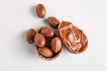 Different delicious Easter eggs with chocolate paste on light background