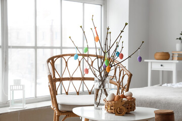 Wicker basket with Easter eggs in interior of bedroom