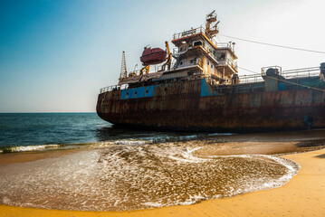 Old, rusty shipwreck on a beach in Varkala, Kerala, India