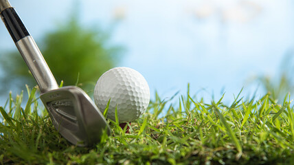 golf ball on tee with iron club head