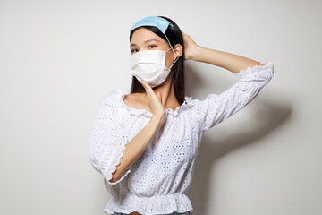 pretty brunette two medical masks on the head protection isolated background unaltered