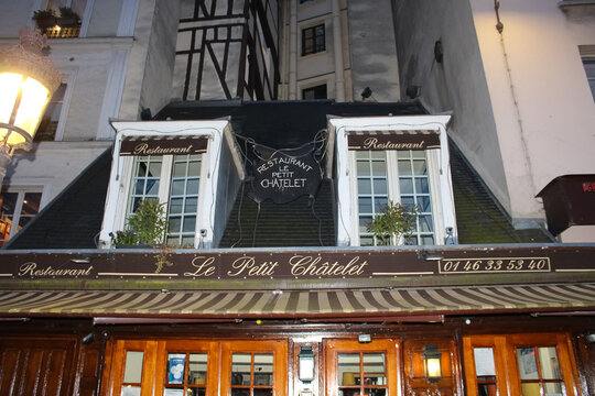 The French traditional restaurant The Little Chatelet located in Latin quarter at rainy night, Paris, France.
