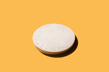 Abstract minimal scene - empty white podium on pastel beige orange background. Cylinder form stand,...