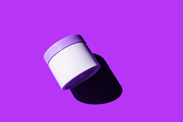 Mock up container on violet very peri background with shadow. Skincare bodycare beauty product in plastic jar. White unbranded creme. Concept of cosmetic presentation and exhibitions. Abstract minimal