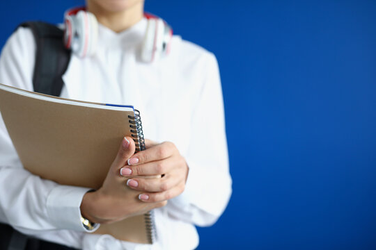 Close-up of student hold stack of books