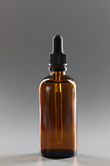 Brown glass bottle filled with oil, flask with cosmetology product or medication