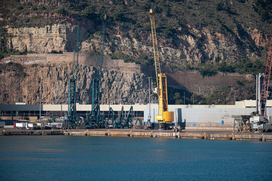 The industrial zone of the port, machinery, cranes, and tractor to carry scrap