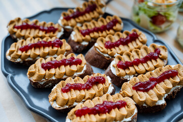 Bruschetta with mascarpone cheese, peanut butter and jam. Healthy Aperitif, sweet snacks. Healthy breakfast, bread with cheese and jam. Light culinary dishes
