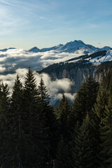Beautiful snowcapped mountains and forest landscape with blue sky at the ski resort of Morzine in the Alps Mountain Range of France, Europe