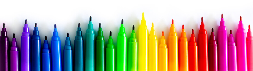 Felt-tip pens on a white background. Multi-colored markers are beautifully folded by the color of the rainbow. Creativity and design concept. - Powered by Adobe