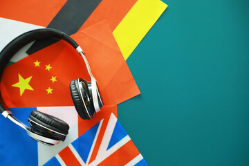 Headphones and flag. The study of foreign subjects. Audiobooks in a foreign language. Language classes. Listening.