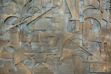 Iron background made of metal parts. The remains and scraps from industrial works are abstractly stacked. Unusual design for the use of unnecessary waste. Old rusty metal.