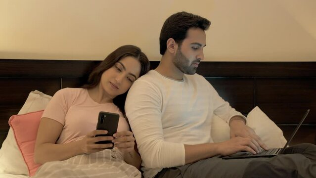 A well-groomed businessman working from home during the Coronavirus pandemic. Pretty female browsing on her mobile while leaning on her best friend - casual resting  tired  bored  a decent human