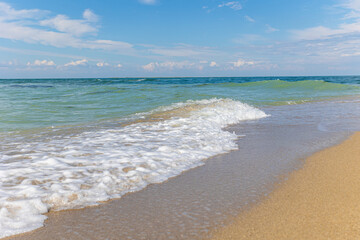 Beautiful bright colorful tropical summer background. Soft turquoise blue ocean wave on golden sandy beach.