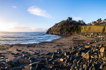 Fototapeta na wymiar Criccieth Castle, above Criccieth Beach at sunrise, North Wales