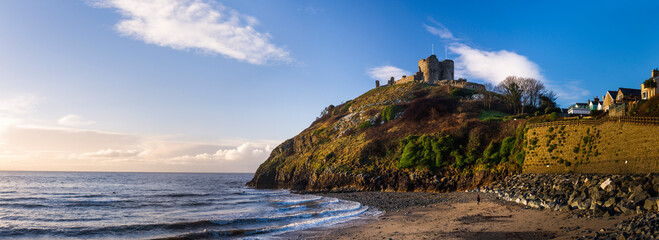 Criccieth Castle, above Criccieth Beach at sunrise, North Wales