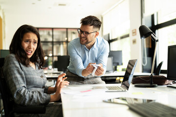 Colleagues arguing in office. Angry businessman yelling at his collegue.