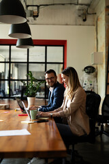 Colleagues in office. Businesswoman and businessman discussing work in office.