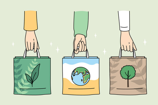 Ecology care and eco-friendly things concept. Human hands holding eco-friendly bags with pictures of plant planet and tree vector illustration 