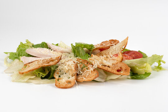 caesar salad on white background. Close up image of delicious ceasar salad white background. Chicken Caesar Salad