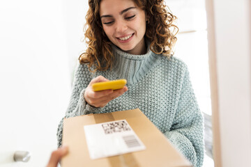 curly-haired woman delivers a package with qr code
