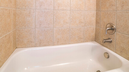 Panorama Alcove bathtub close up with brown ceramic tiles surround