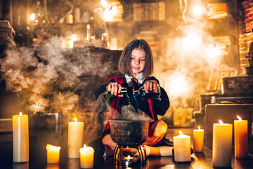  little girl in witch Cosplay brews potion, Halloween costume. Halloween party. Cosplay Harry Potter