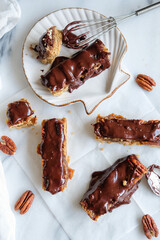 Delicious and healthy homemade snacks. Vegan Chocolate Bar with Nuts and Dates. Fresh ingredients...