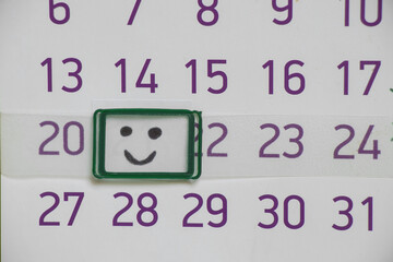calendar with a painted smile on one day for the background