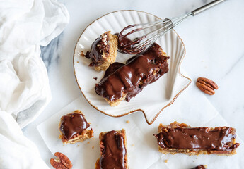 Delicious and healthy homemade snacks. Vegan Chocolate Bar with Nuts and Dates. Fresh ingredients from the supermarkets, medjool dates, peanut butter, pecan, oats, maple syrup, coconut oil and cacao.