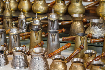 Fototapeta na wymiar Coffee makers, Turkish coffee metal Turk cone with wooden handles, selective focus.