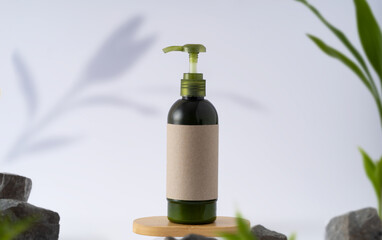 Lotion or shampoo bottle with brand mockup space on wooden platform Green leaves and stones as a frame. Natural product or cosmetics concept