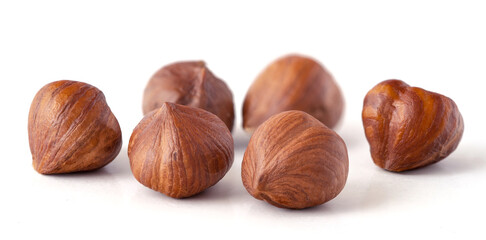 Side view photo of unshelled raw hazelnuts on isolated white background. Healthy diet concept