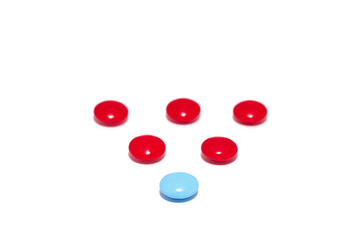 A scattering of red and blue pill capsules on a white background. Pharmaceuticals, medicines, vitamins. .A package of red and blue tablets is placed on a white background