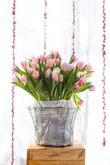 Tulip flower bouquet over blurred white sheer curtain background, valentine gift, wedding day, spring season