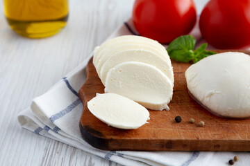 Homemade Mozzarella Cheese with Tomato, Basil and Olive Oil, low angle view. Close-up.