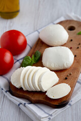 Homemade Mozzarella Cheese with Tomato, Basil and Olive Oil, side view.