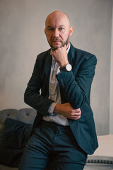 Business portrait of a bald man, office man in a jacket