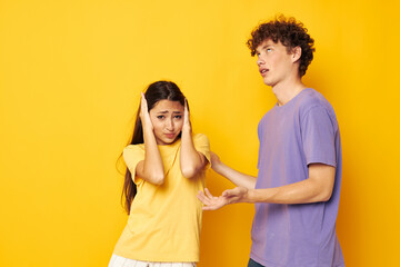 portrait of a man and a woman in colorful t-shirts posing friendship fun isolated background unaltered