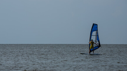 Fototapeta premium Windsurfing. Entertainment at sea, extreme sports, lifestyle during the summer holidays