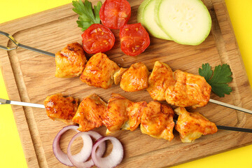 Concept of tasty food with chicken shashlik on yellow background