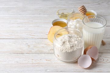 Ingredients for pie or cake cooking on wooden table
