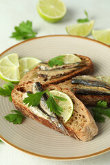 Concept of tasty snack with sandwiches with sprats