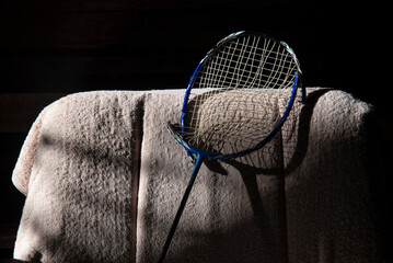 broken badminton racket bend on chair backrest