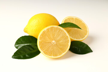 Lemons and leaves on white background, close up