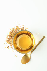 Concept of hot drink with buckwheat tea on white background