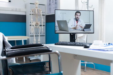 Compute screen with remote doctor talking during online videocall meeting conference standing on...