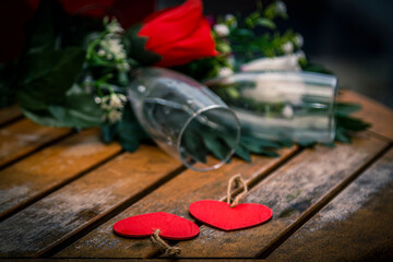 Valentine's day or birthday festive banner with red wine, heart label and red roses on wooden background. Greeting card. Copy space.