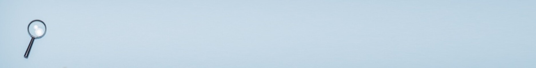 Banner with magnifying glass on a blue background with a place for text: finding 