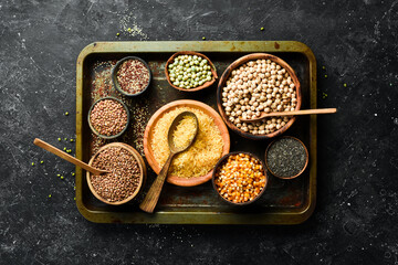 Various cereals and legumes: rice, peas, lentils, beans, mung beans, buckwheat, chia, corn and chickpeas. Top view. Banner in the title of the site